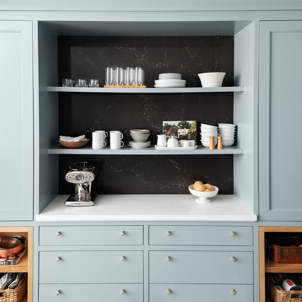 Kitchen shelving with a Cambria Foggy City quartz counter and a wall cladding with Cambria Charlestown quartz.