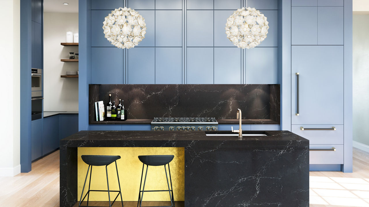 Modern kitchen with blue cabinets and hanging light fixtures with Charlestown quartz countertops and backsplash