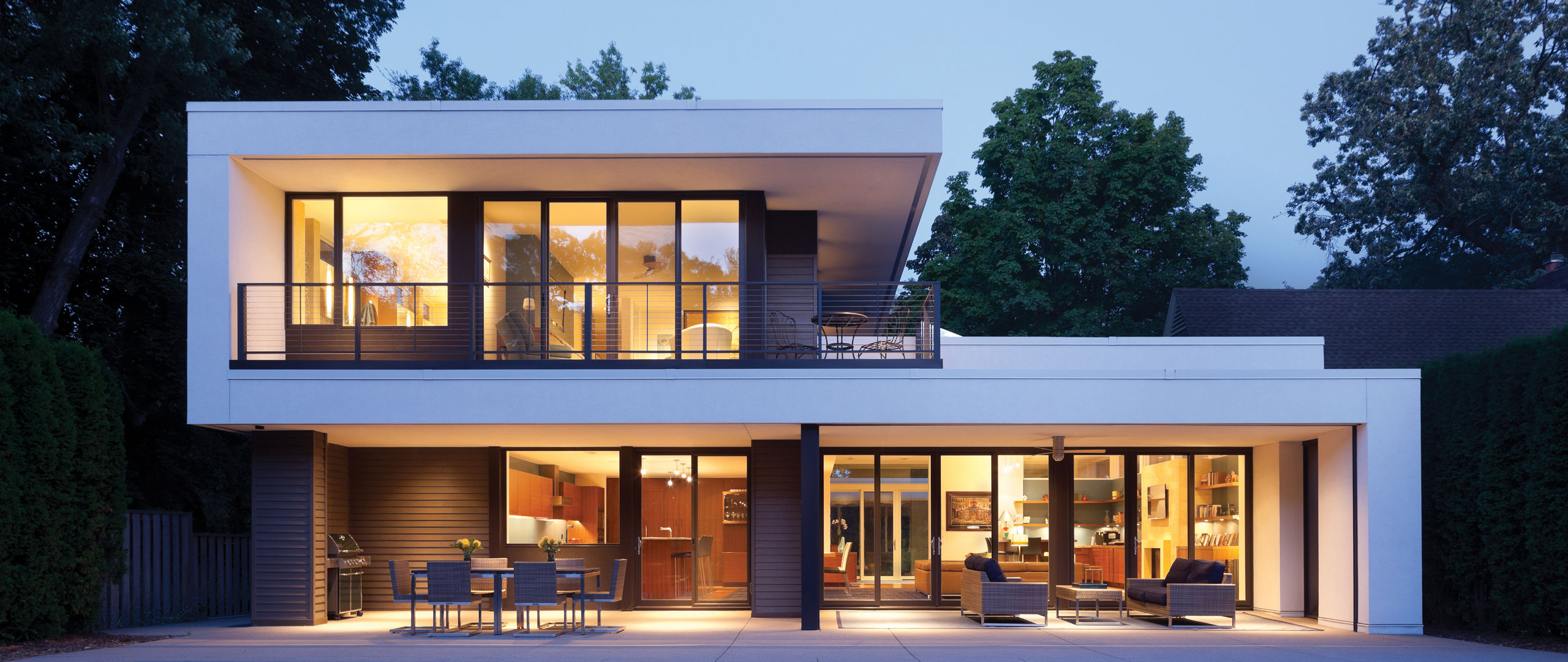 An exterior shot of a modern home with a pool.