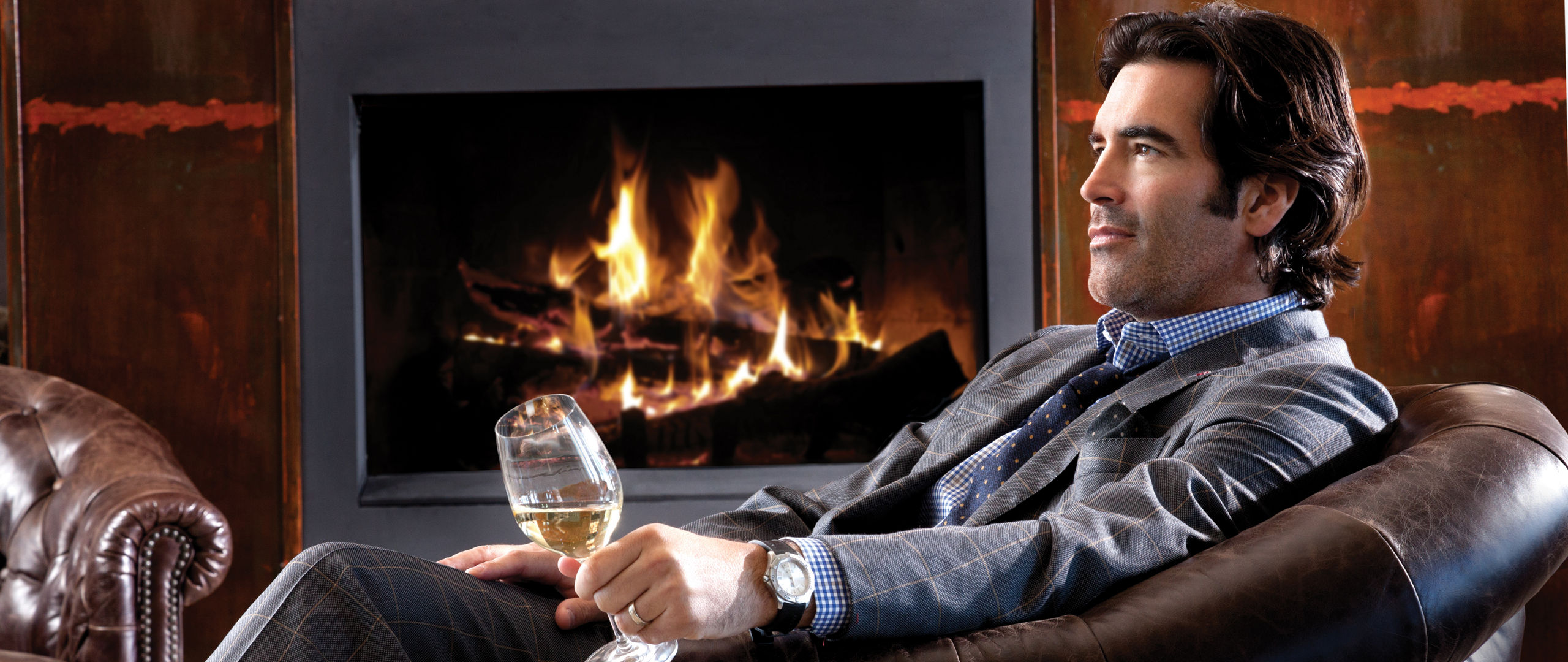 Carter Oosterhouse posing in front of his fireplace in his Michigan home.