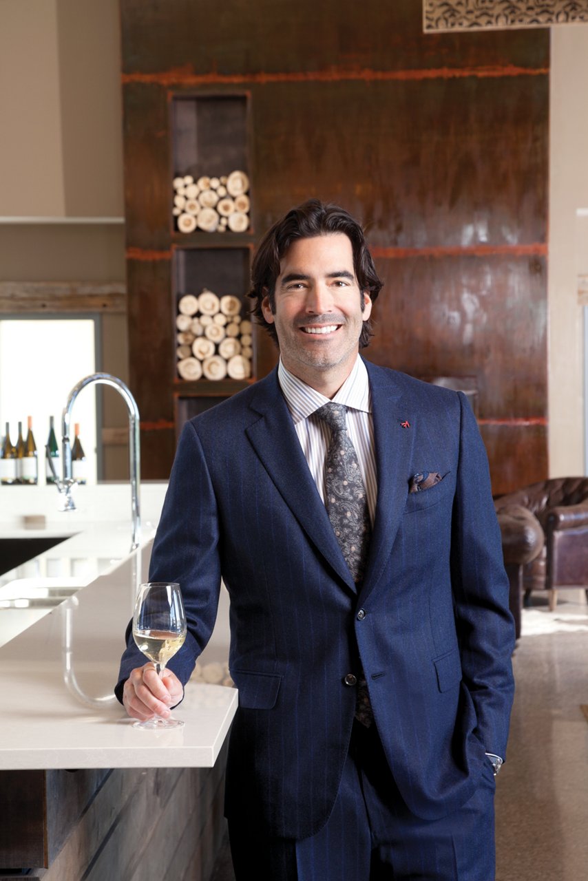 Carter Oosterhouse posing in his renovated kitchen from Cambria.