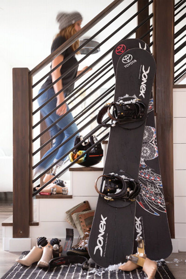 Amy Purdy, paralympic snowboarder, poses for a photo in front of her gear.