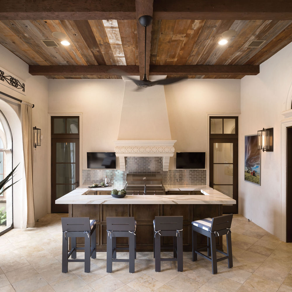 a traditional kitchen with wooden cabinets, white quartz countertops, wooden ceilings, and tiled flooring.