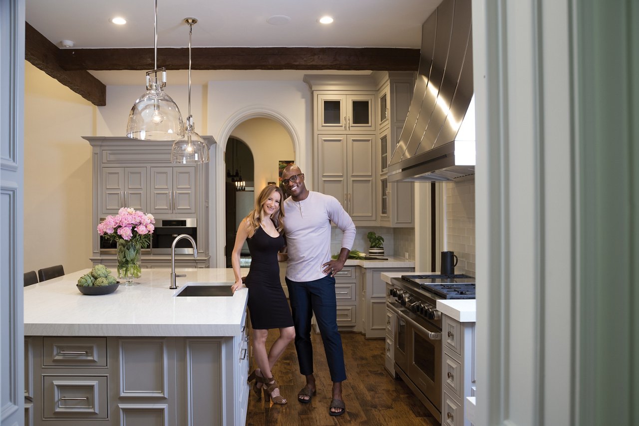 Angela and DeMarcus Ware’s Cambria Delgatie™ countertops contrast the cool cabinets painted Sherwin-Williams Pussy Willow.