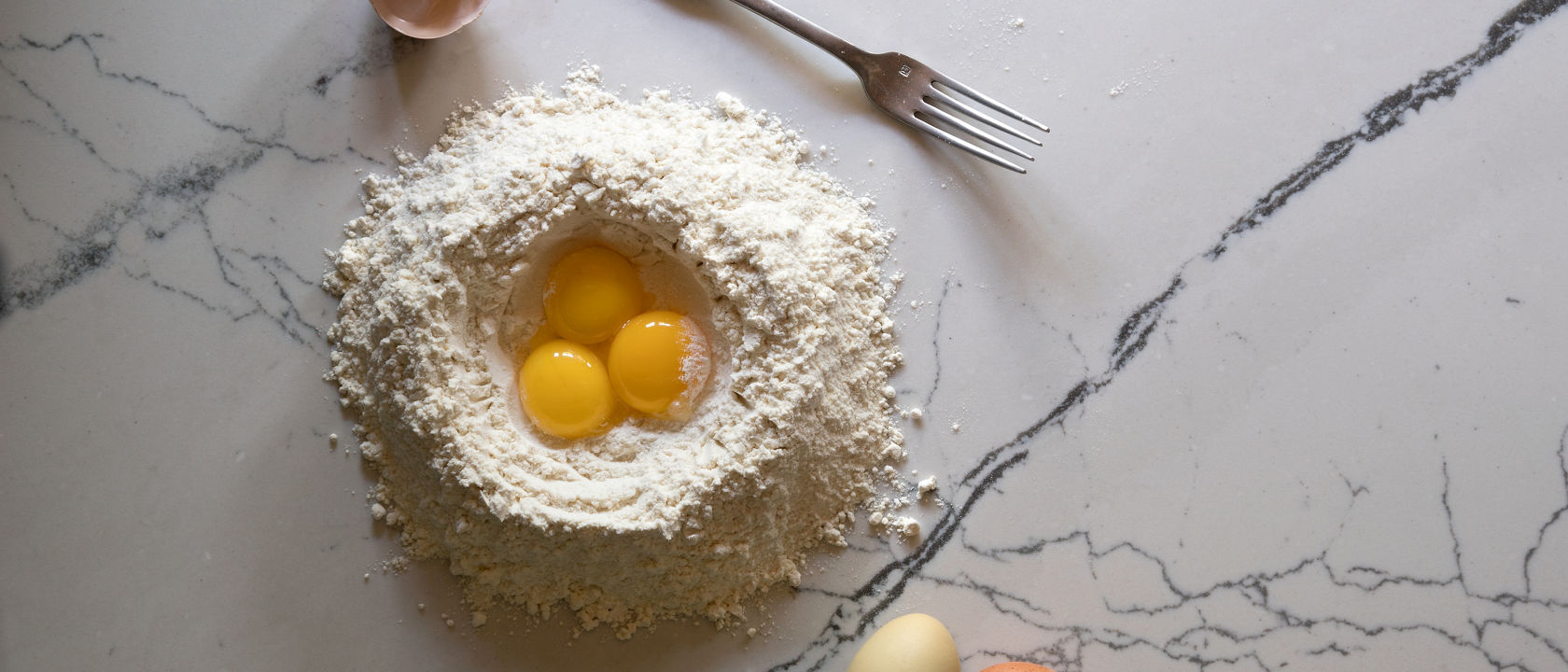 The start of a pasta dough made on top of nonporous, maintenance-free, easy-to-clean quartz countertops. 