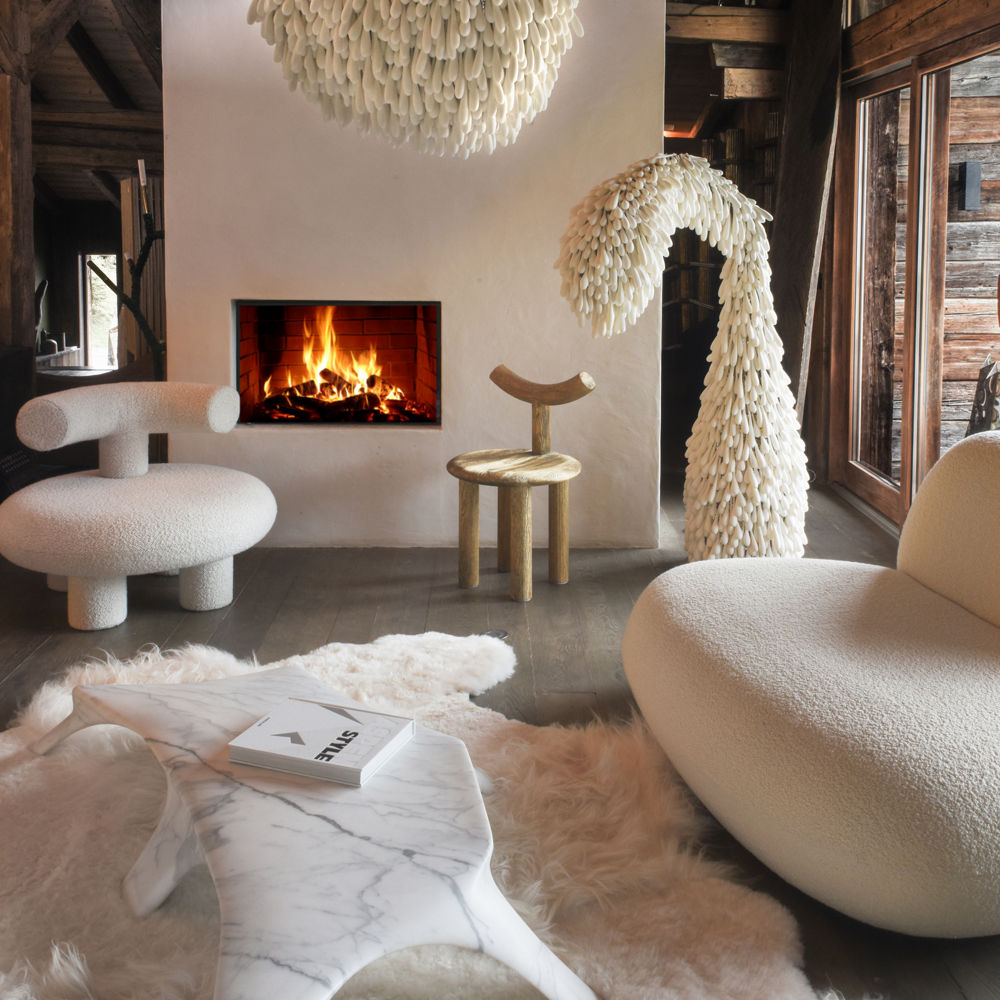 a fun living room with a white shag rug, organic furniture, and a white fireplace.
