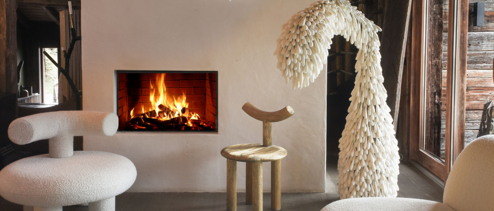 a fun living room with a white shag rug, organic furniture, and a white fireplace.