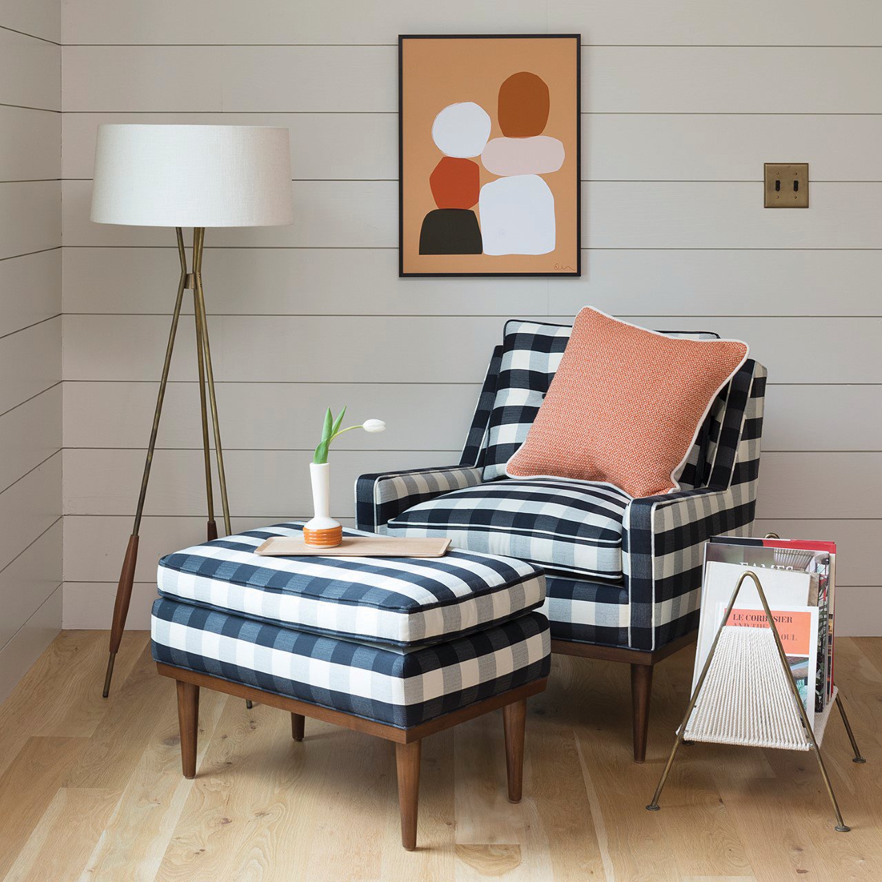 A navy and white plaid armchair with matching ottoman.