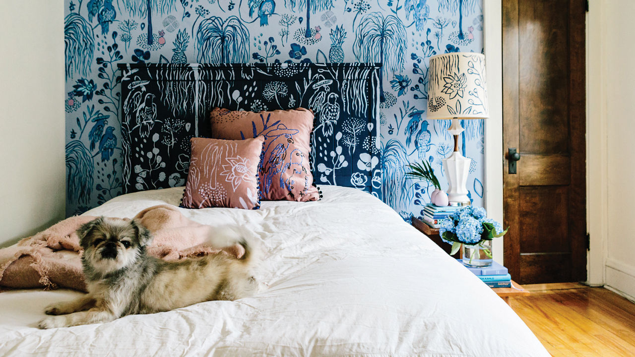 A bedroom with a gorgeous blue painted mural.