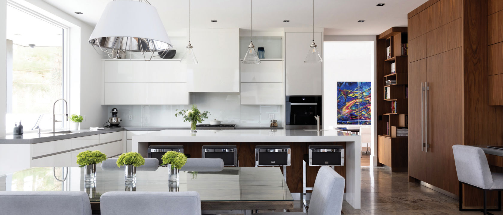 a contemporary kitchen with white and wooden cabinets, white quartz countertops, and tiled flooring.