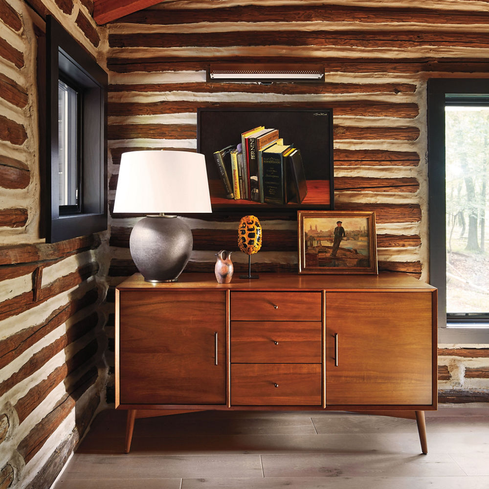 a wooden dresser with various decoration in it and a cabin-style room.