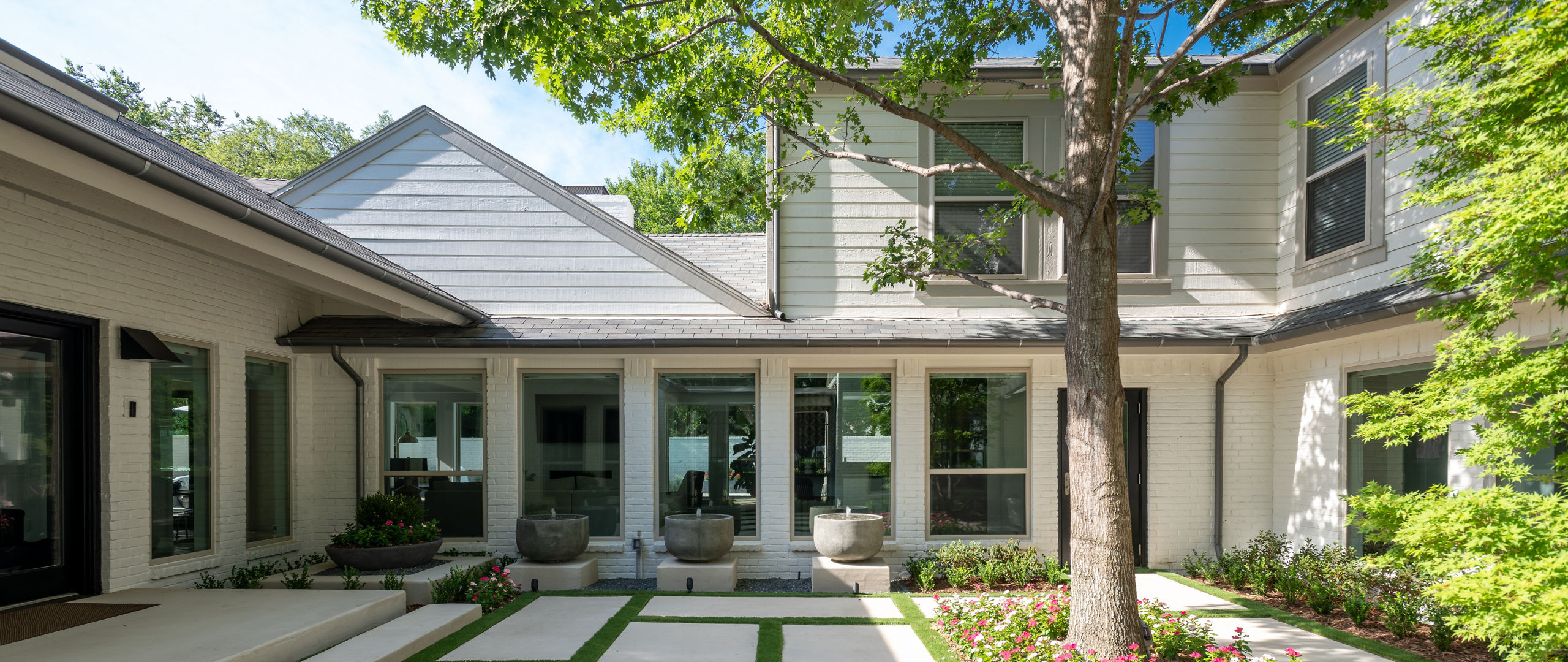 an exterior shot of a home with a unique landscaped path.