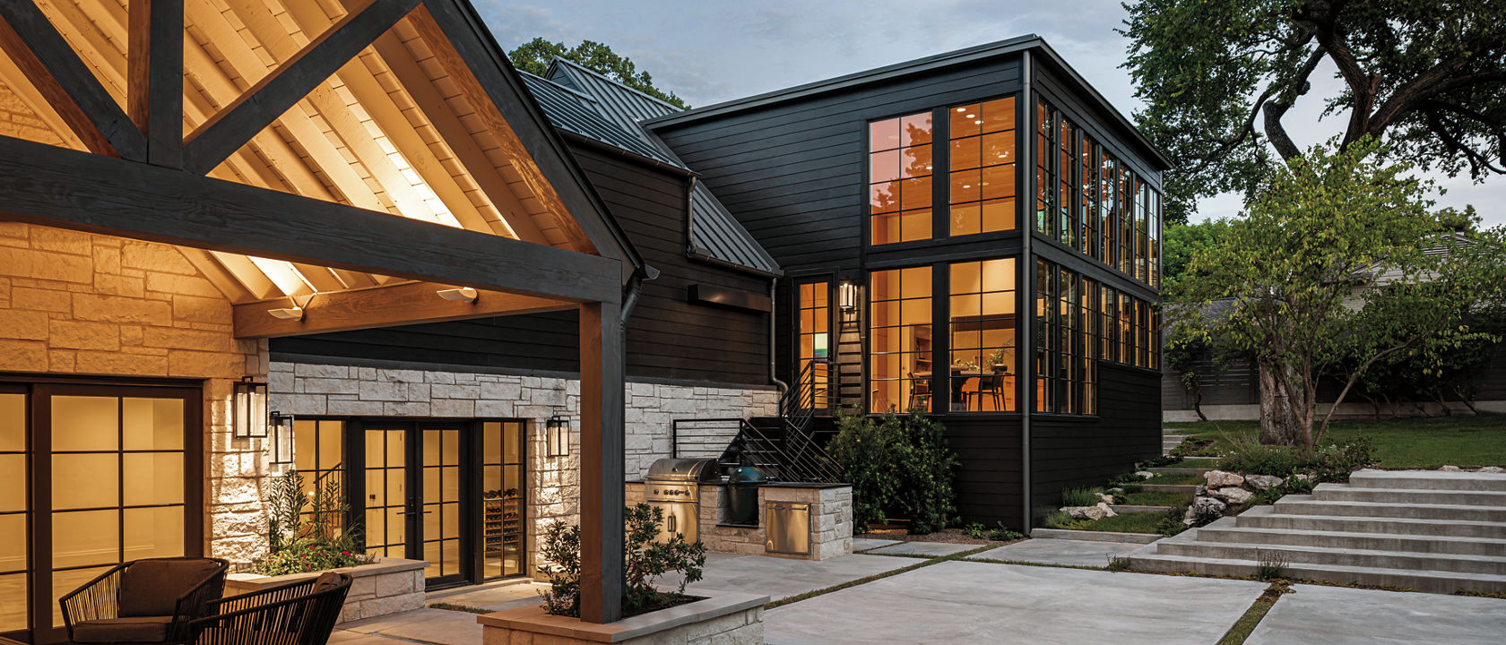 A modern, wood inspired house with a covered patio, expansive terrace, and a pool. 