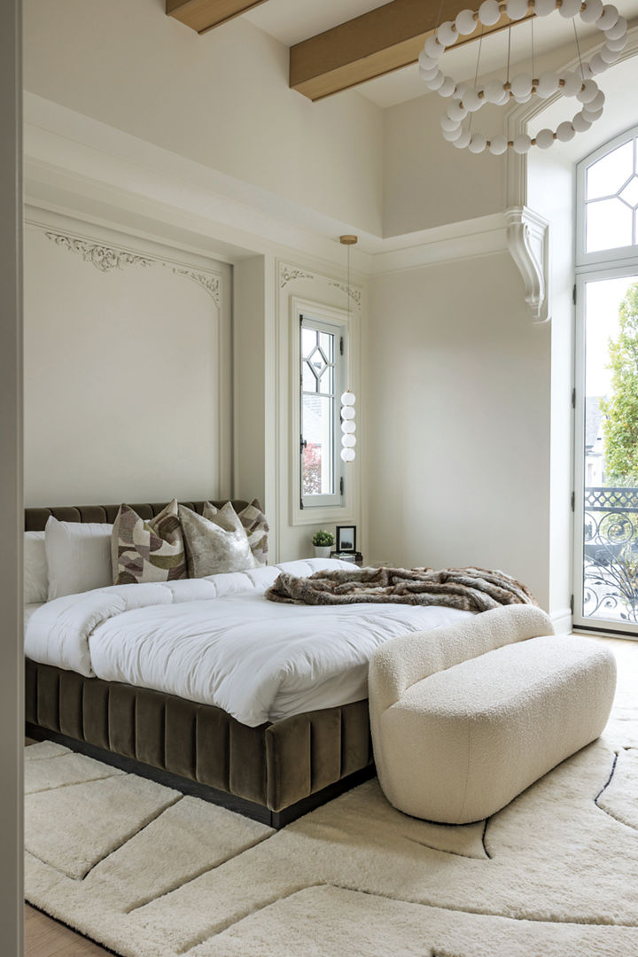 A furnished bedroom with oxidized gold lighting fixtures from Matteo Lighting.