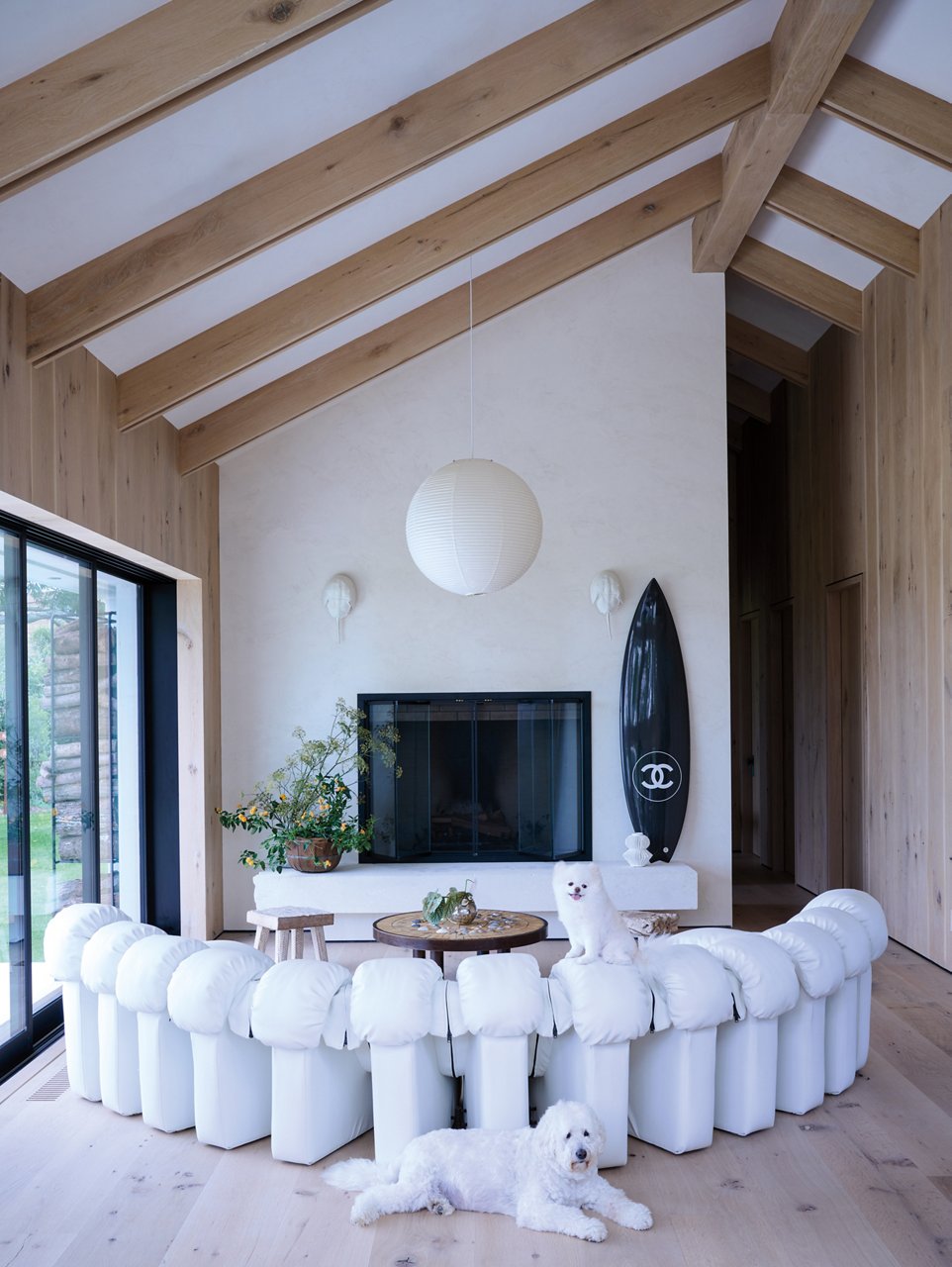 Sasha Bikoff's living room with a couch, fireplace, table and two dogs.