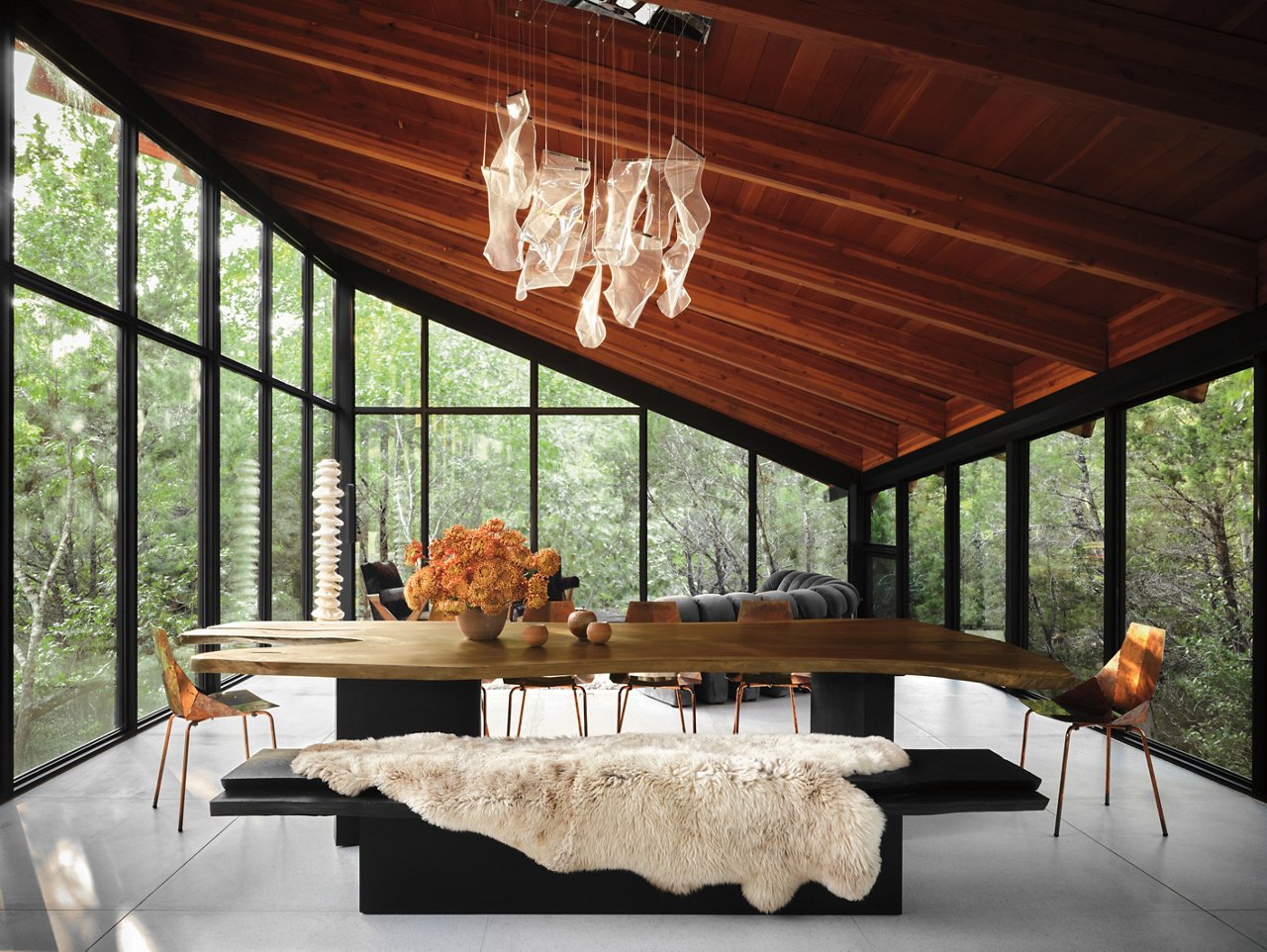 Dining area featuring a live-edge table and a blackened-cedar and mahogany bench