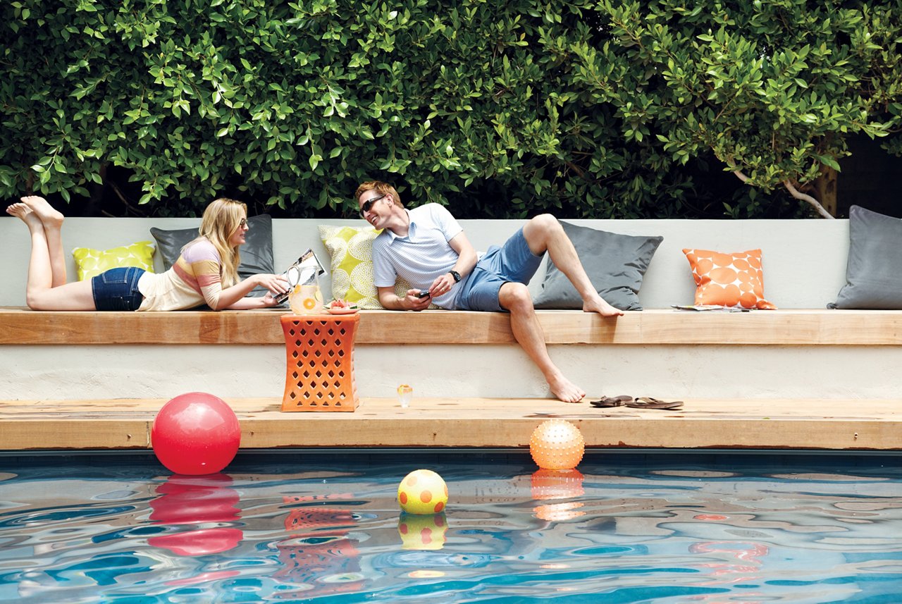 Jessica Capshaw and her husband hanging out near their pool.