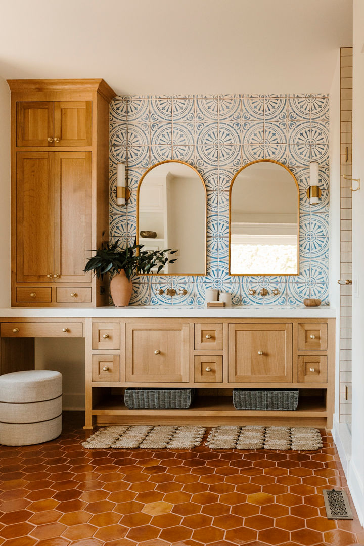 A bathroom with colorful wallpaper and Delgatie quartz countertops
