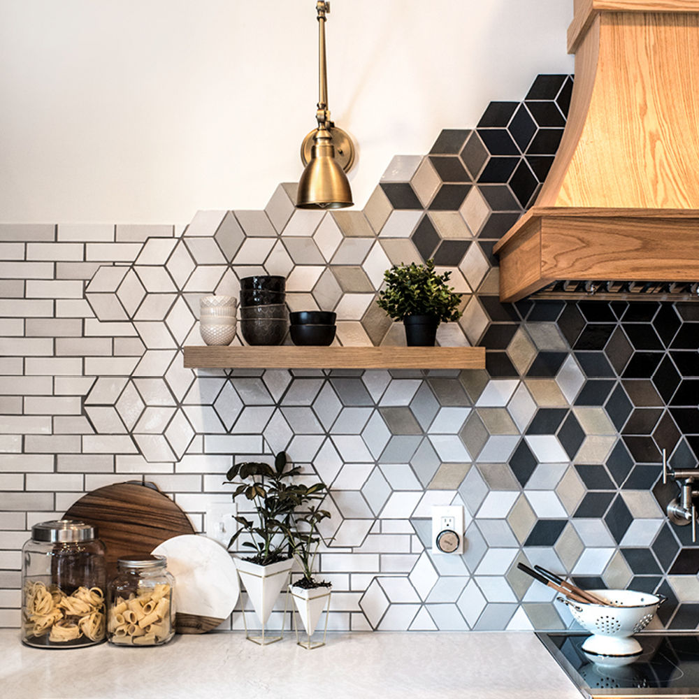 A unique tiled backsplash featuring white and black subway tile and cube-looking shapes.