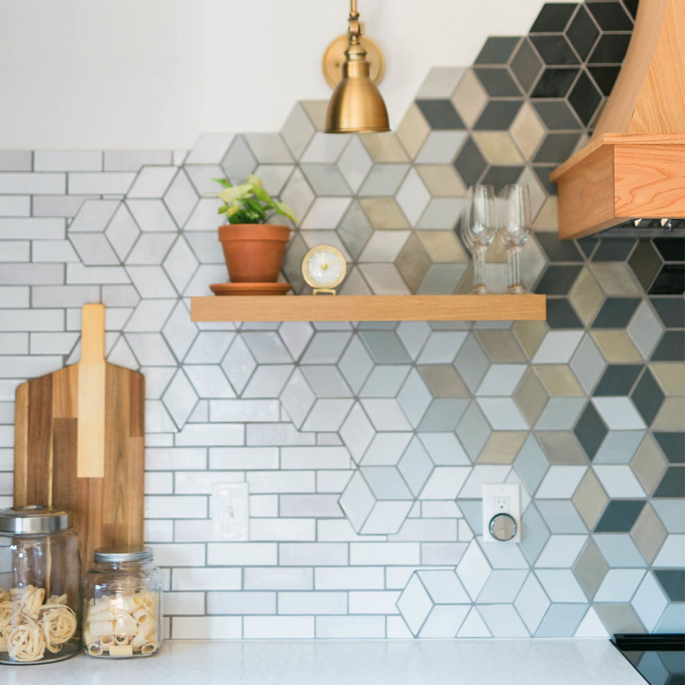Kitchen counter and wall featuring a Cambria Delgatie Matte countertop and a mosaic-tile background with black matte and a mix of colors.