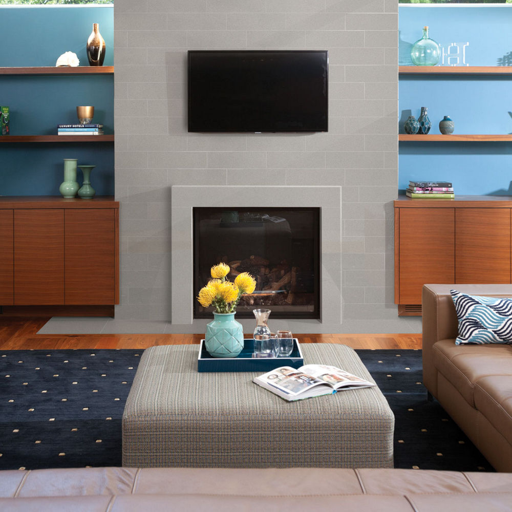 a living room with a gray quartz fireplace.