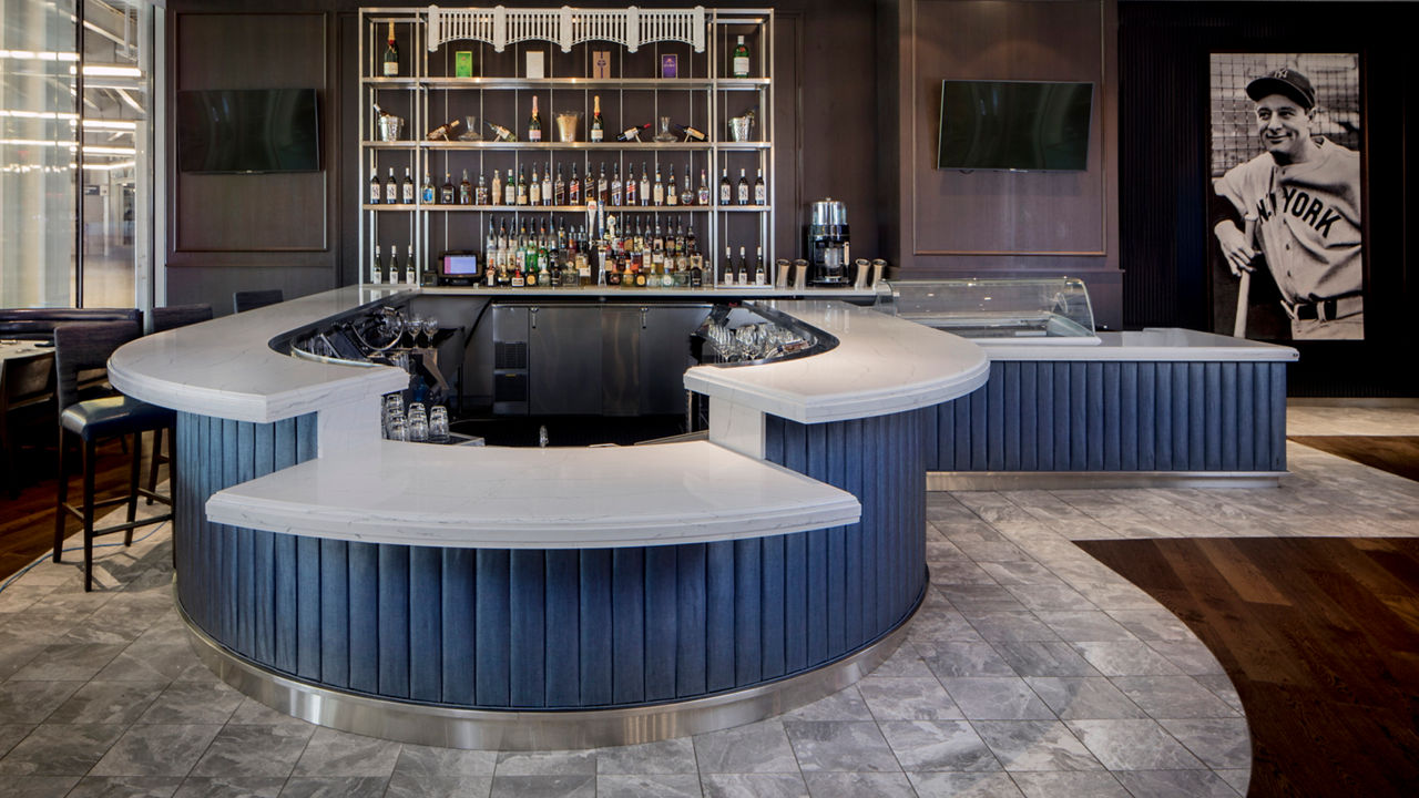 A rounded bar at Yankee Stadium's Legends Bar featuring a Cambria Ella quartz countertops.