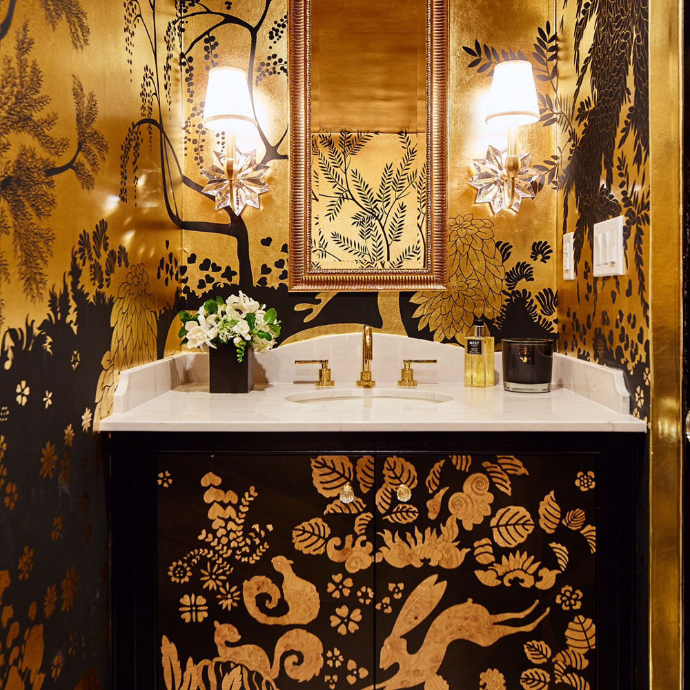 A gorgeous black and gold powder room highlighted by a Cambria Ella quartz countertop sink
