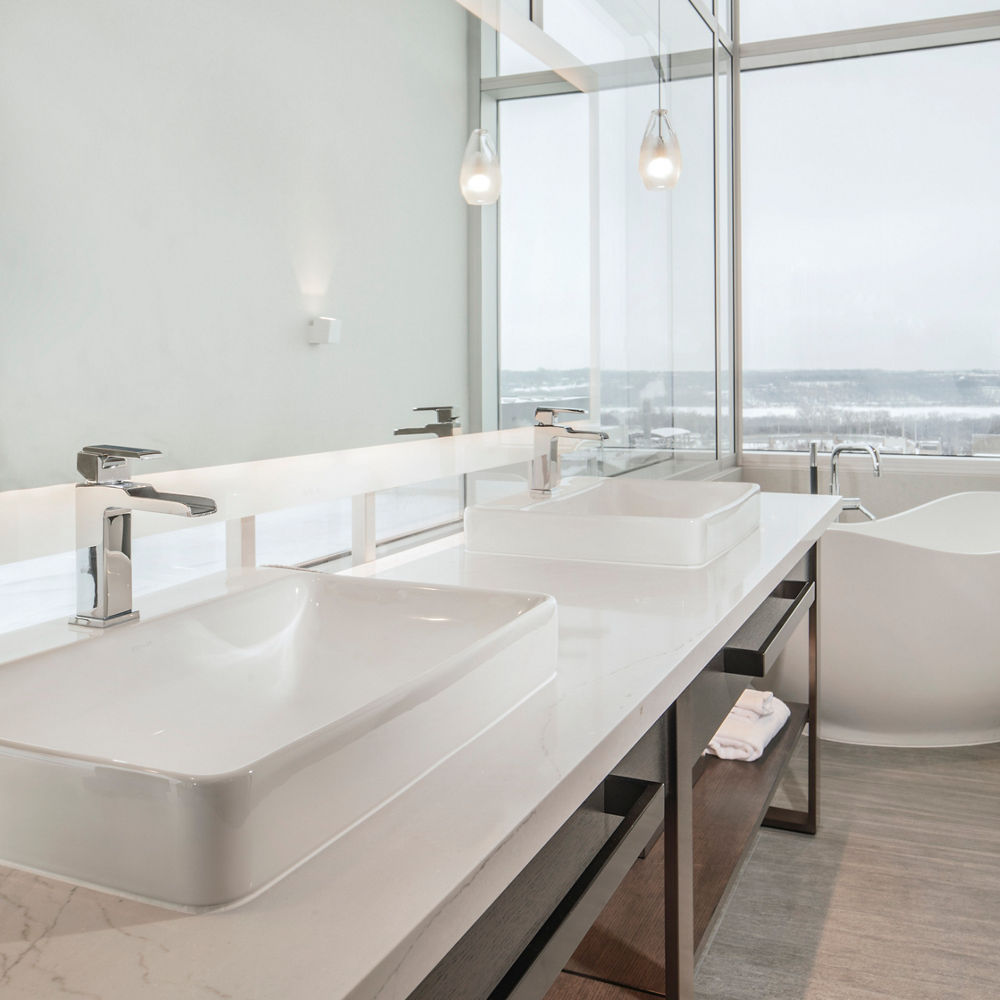A bathroom at the Intercontinental Hotel featuring Ella™ quartz countertops.