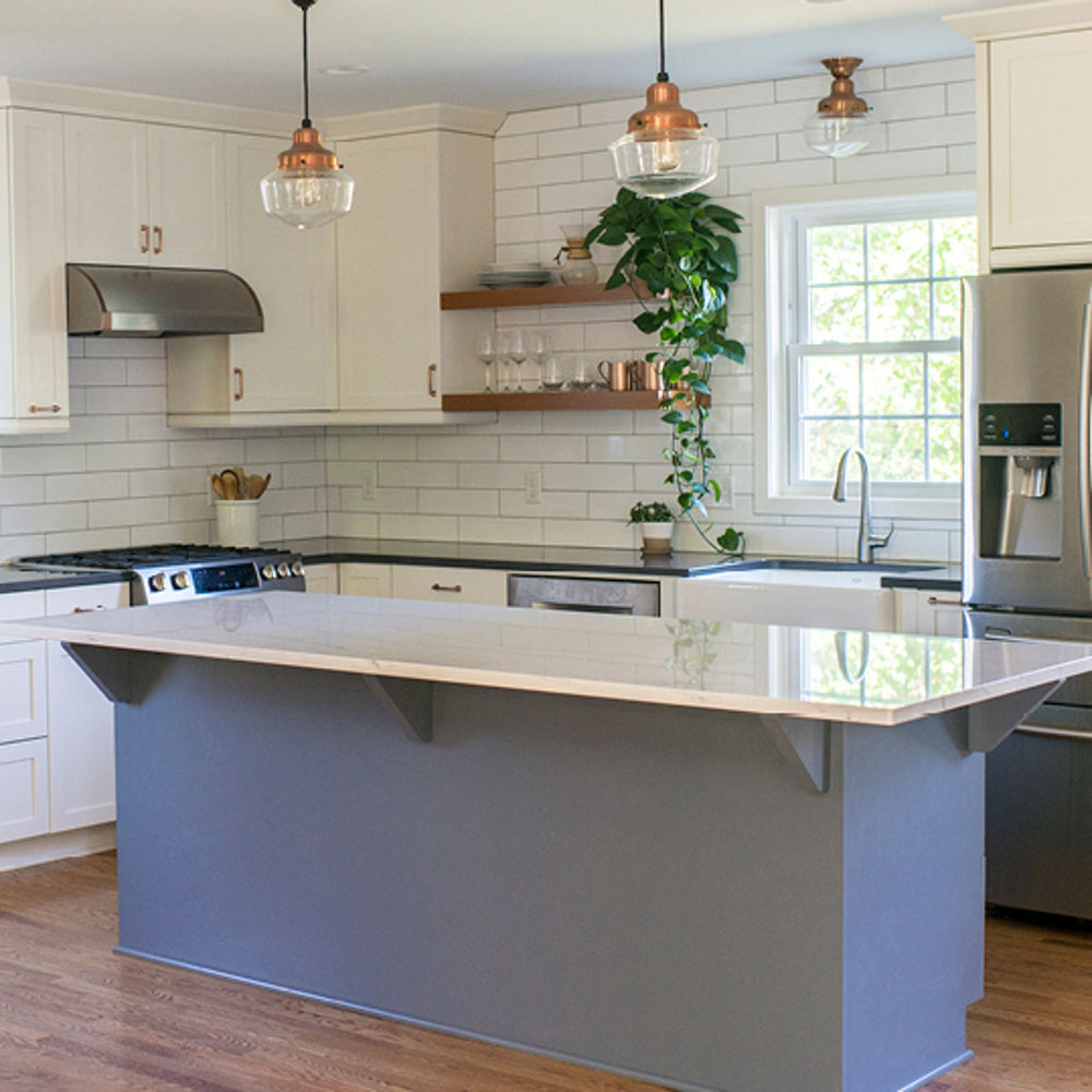 A sleek kitchen design with Cambria Ella and Cambria Fieldstone quartz countertops