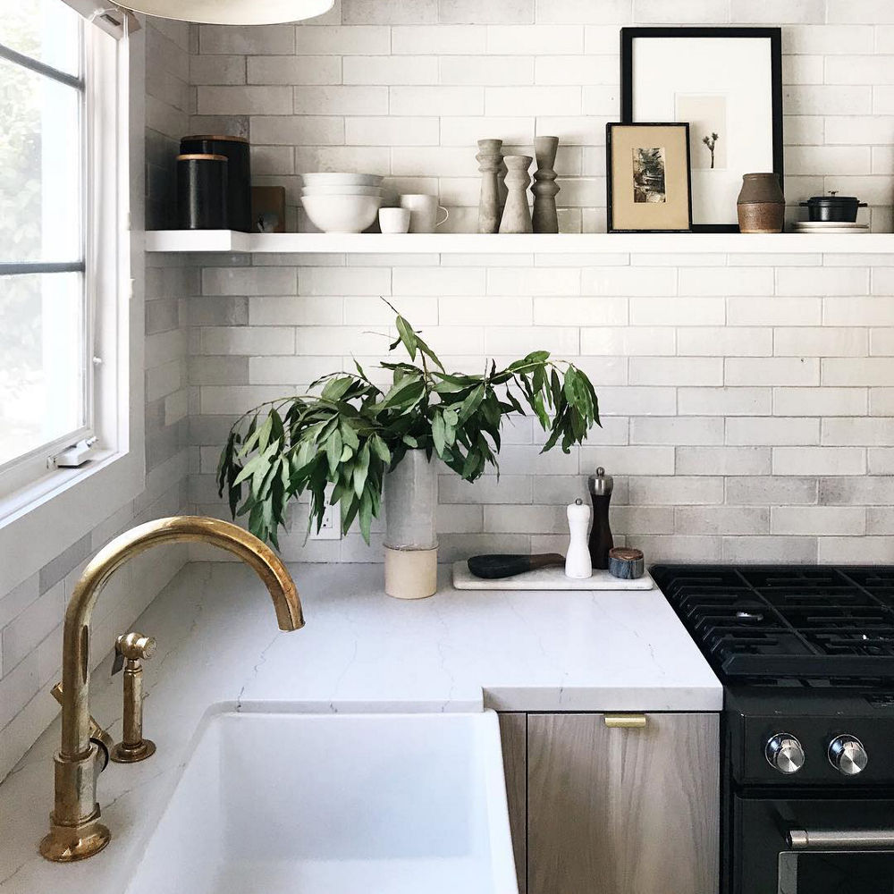 Corner of kitchen featuring a Cambria Ella Matte quartz countertop and black matte accessories.