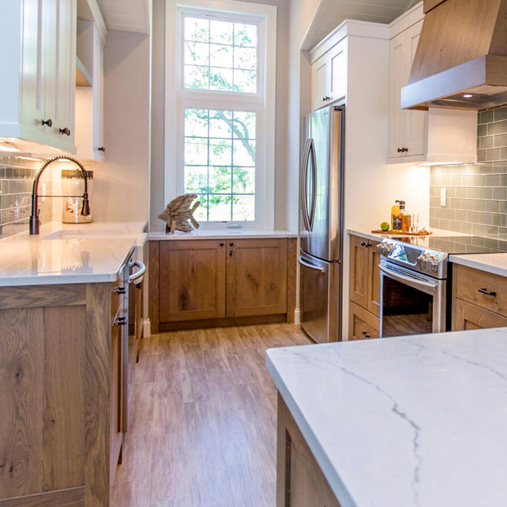 Lake-house kitchen renovation by Jkath Design Build and Reinvent featuring Ella countertops.