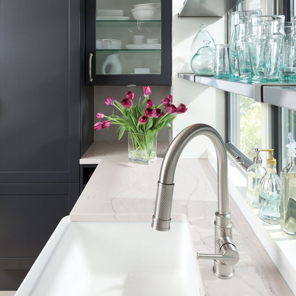 a gorgeous kitchen with matte black cabinets, white quartz countertops, open shelving, and large windows.