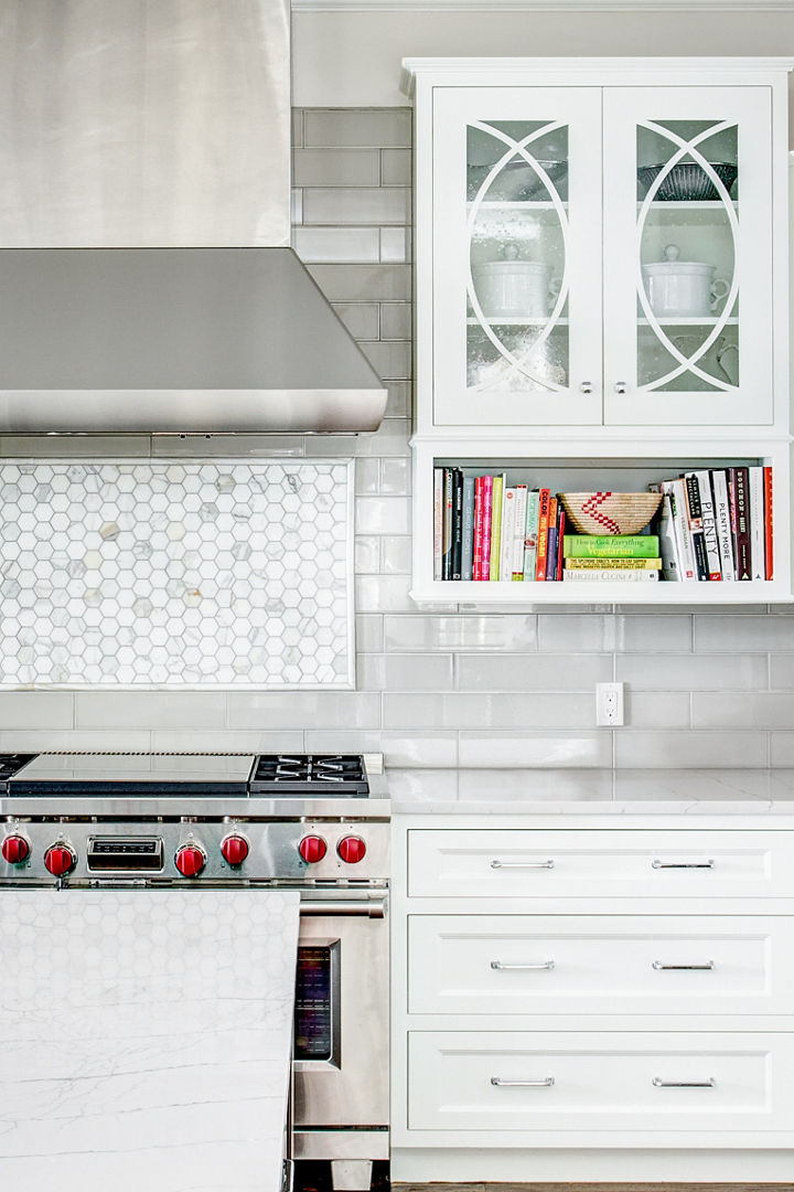 A bright kitchen with a bookcase hanging above a Cambria Ella quartz countertop.