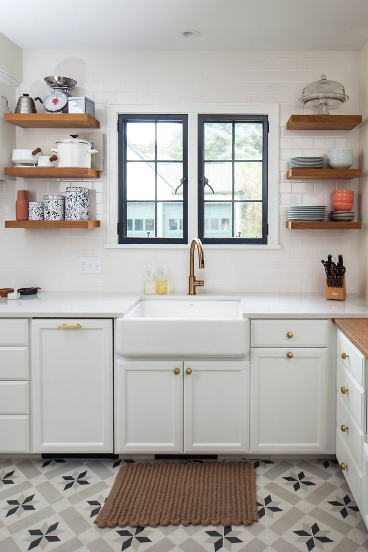 Black and white kitchen with farmhouse sink with brass faucet and Ella countertop