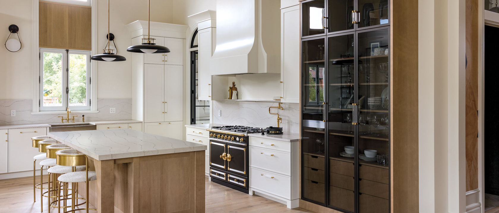 Kitchen with a counter and island featuring Cambria Ella quartz countertops.