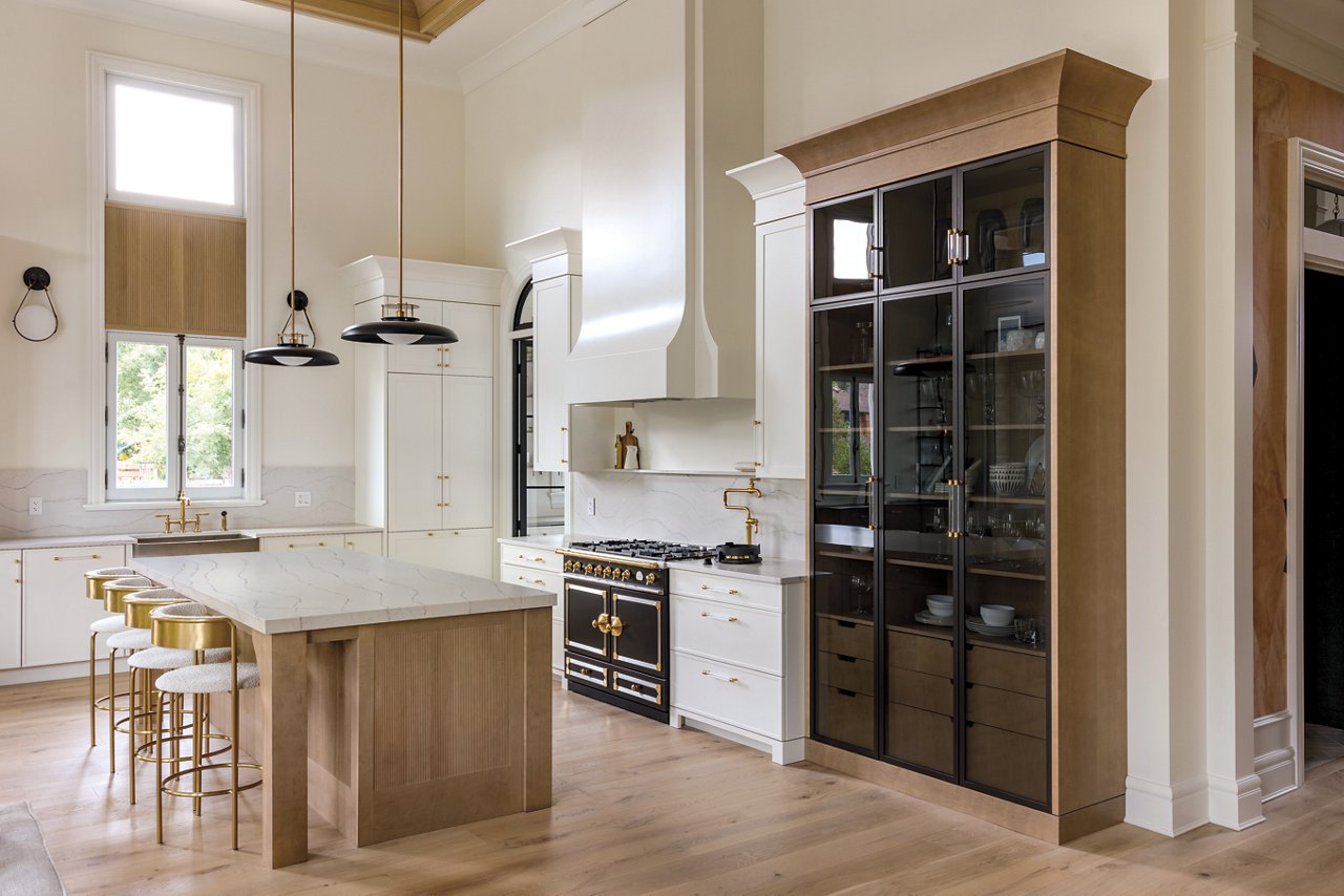 Kitchen with a counter and island featuring Cambria Ella quartz countertops.