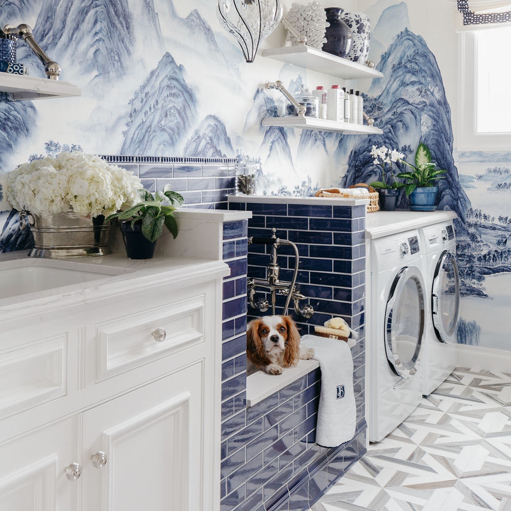 Cambria Ella quartz laundry room with white countertops and a blue-tiled pet shower.