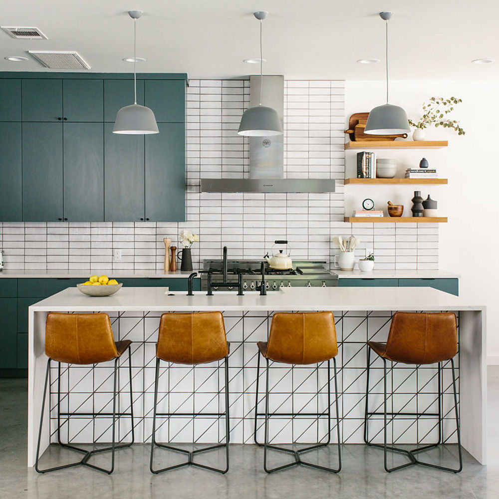 A stylish dark teal and white kitchen design with Cambria Ella Matte countertops
