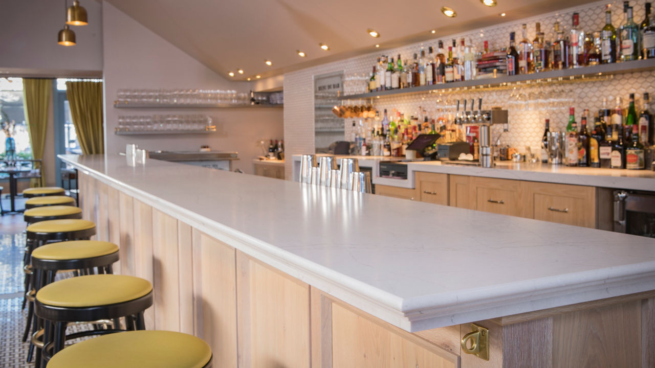 A bar with a counter featuring a Cambria Ella Matte quartz countertop.