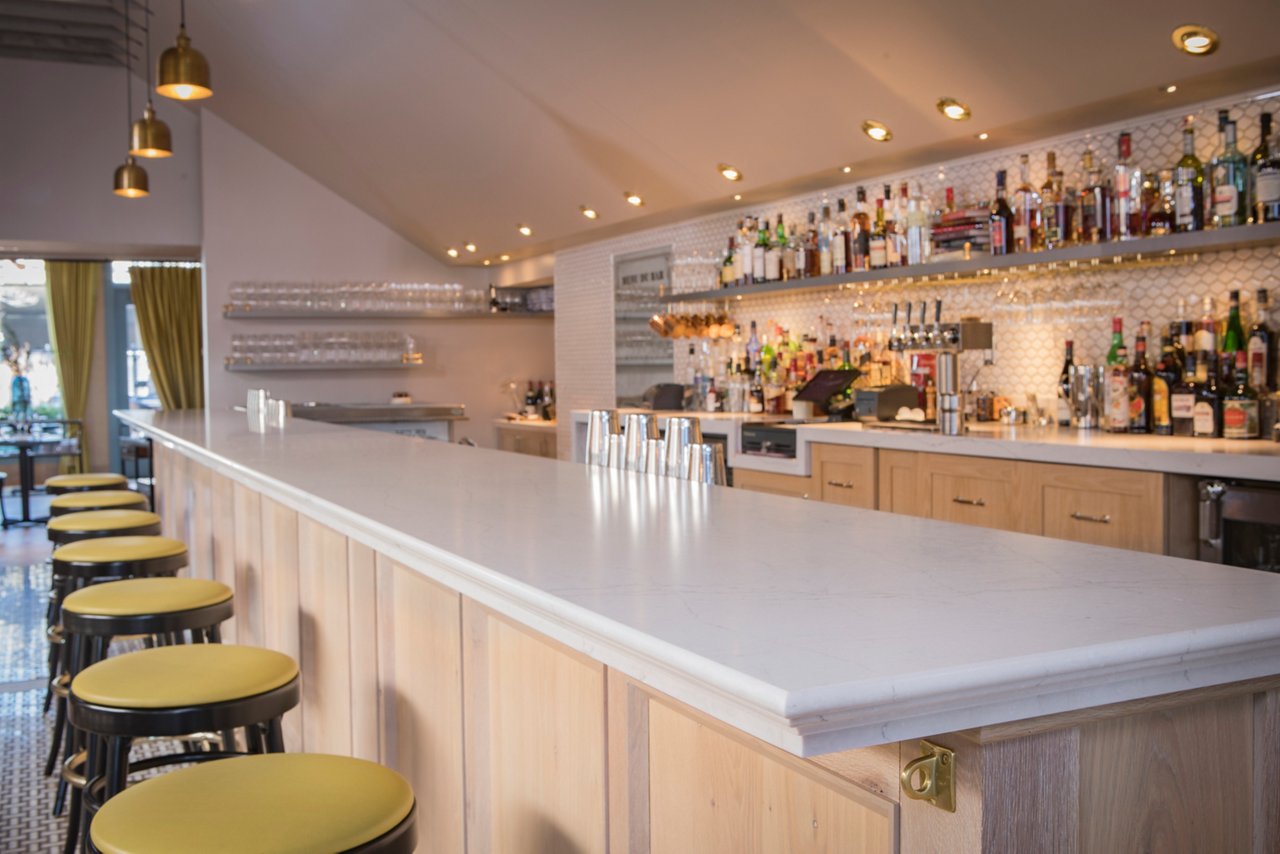 A bar with a counter featuring a Cambria Ella Matte quartz countertop.