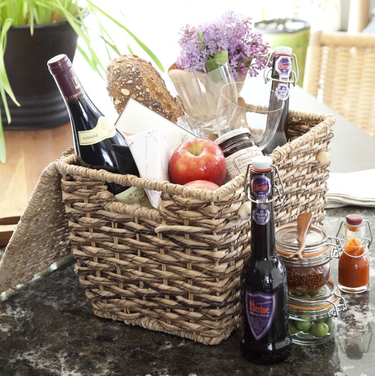 A wine and fruit filled picnic basket atop a Cambria Ellesmere countertop