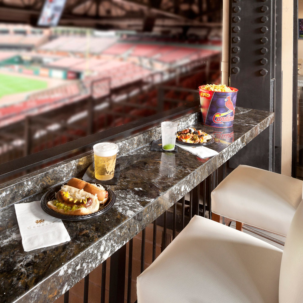 An black quartz drink rail serves up game-day fare in this Busch Stadium suite in St. Louis