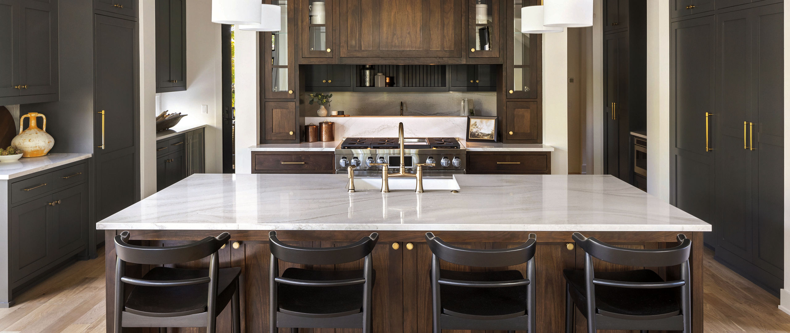 everleigh quartz kitchen island with backsplash and dark cabinetry