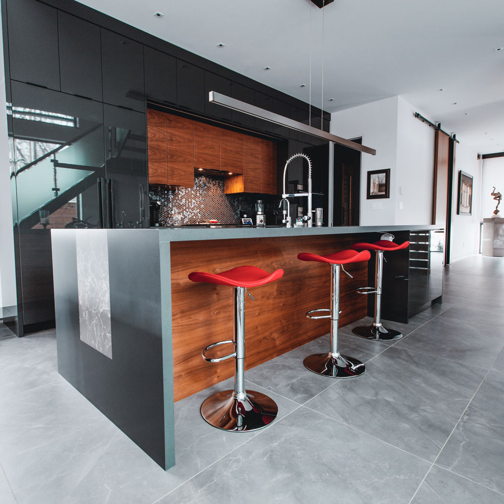 A sleek black and dark wood kitchen with Cambria Fieldstone Matte countertops