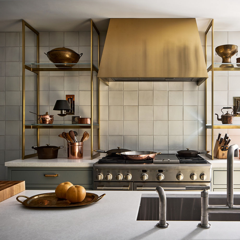 A sleek white and brass kitchen with Cambria Foggy City Matte quartz countertops