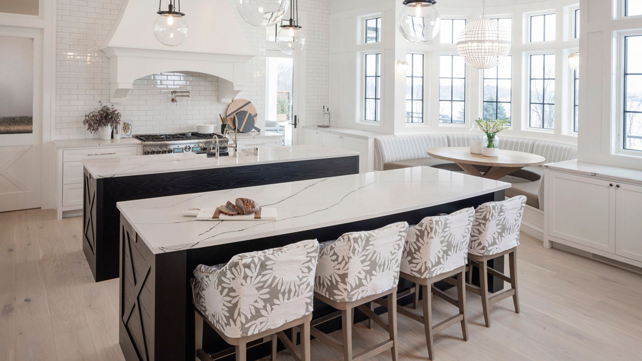 Kitchen with two islands featuring Cambira Gladstone quartz countertops.