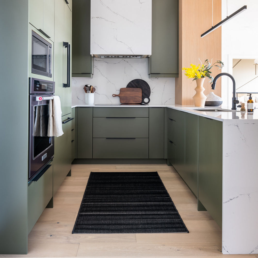 Cambria Hawksmoore countertop accenting olive kitchen design showcasing cabinetry