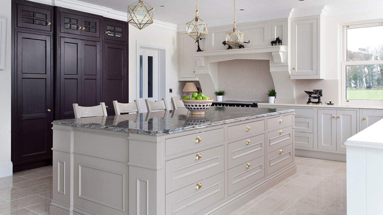 A big kitchen with center island made of cream cabinets and topped with Cambria Hemsley quartz countertops.