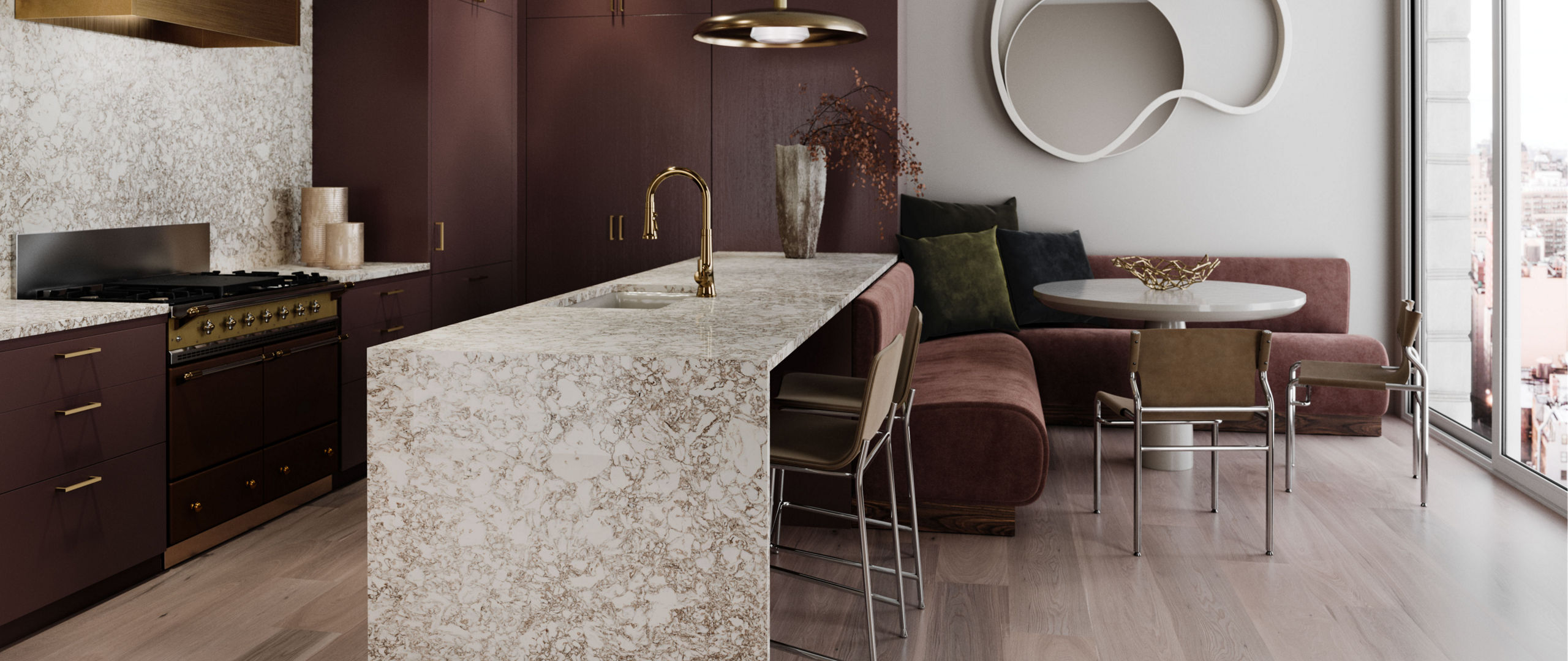 A gorgeous kitchen with dark mahogany cabinets, Cambria Hermitage™ quartz countertops, a gold hood over the range, gold pendant lighting, and a double waterfall kitchen island made from quartz. 