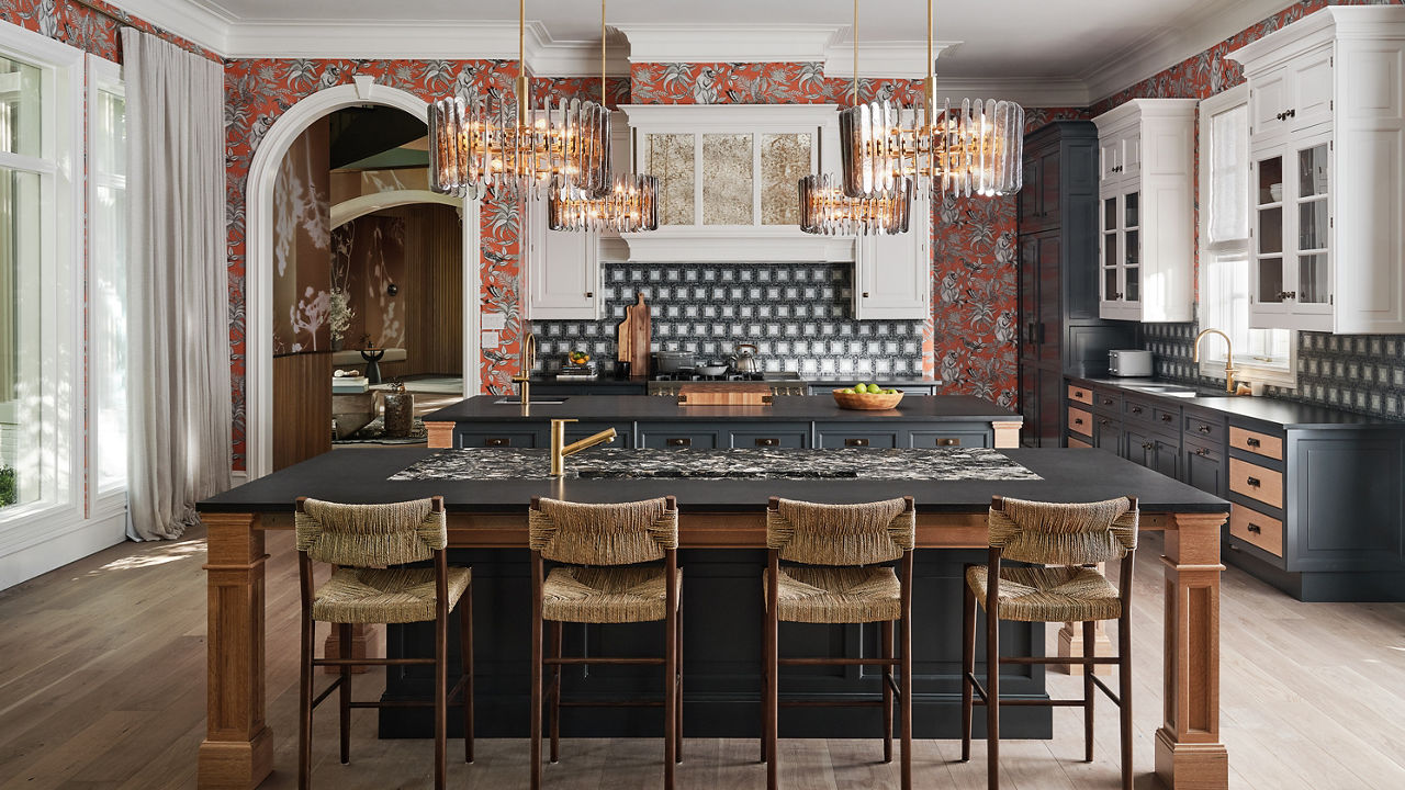 A large kitchen with floral wallpaper, blue tile backsplash and two toned cabinets with Hollinsbrook Matte and Montana Midnight Matte Quartz Countertops